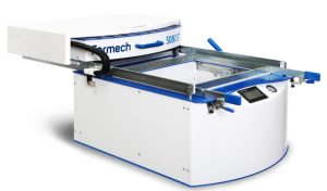 The operator monitors the entire operation in manual vacuum forming machine