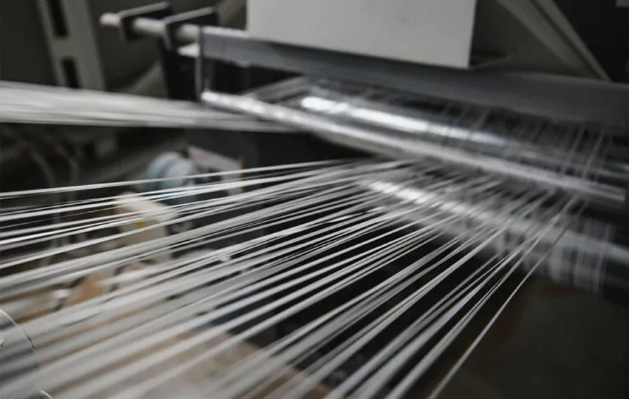 Polypropylene resin is melted, formed into tapes, ensuring tensile strength for bags